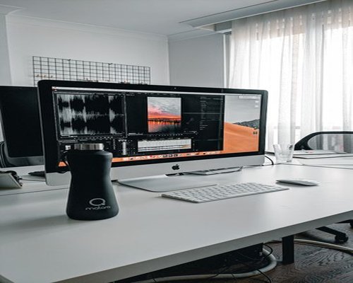 Water bottle securely placed on a desk beside a computer
